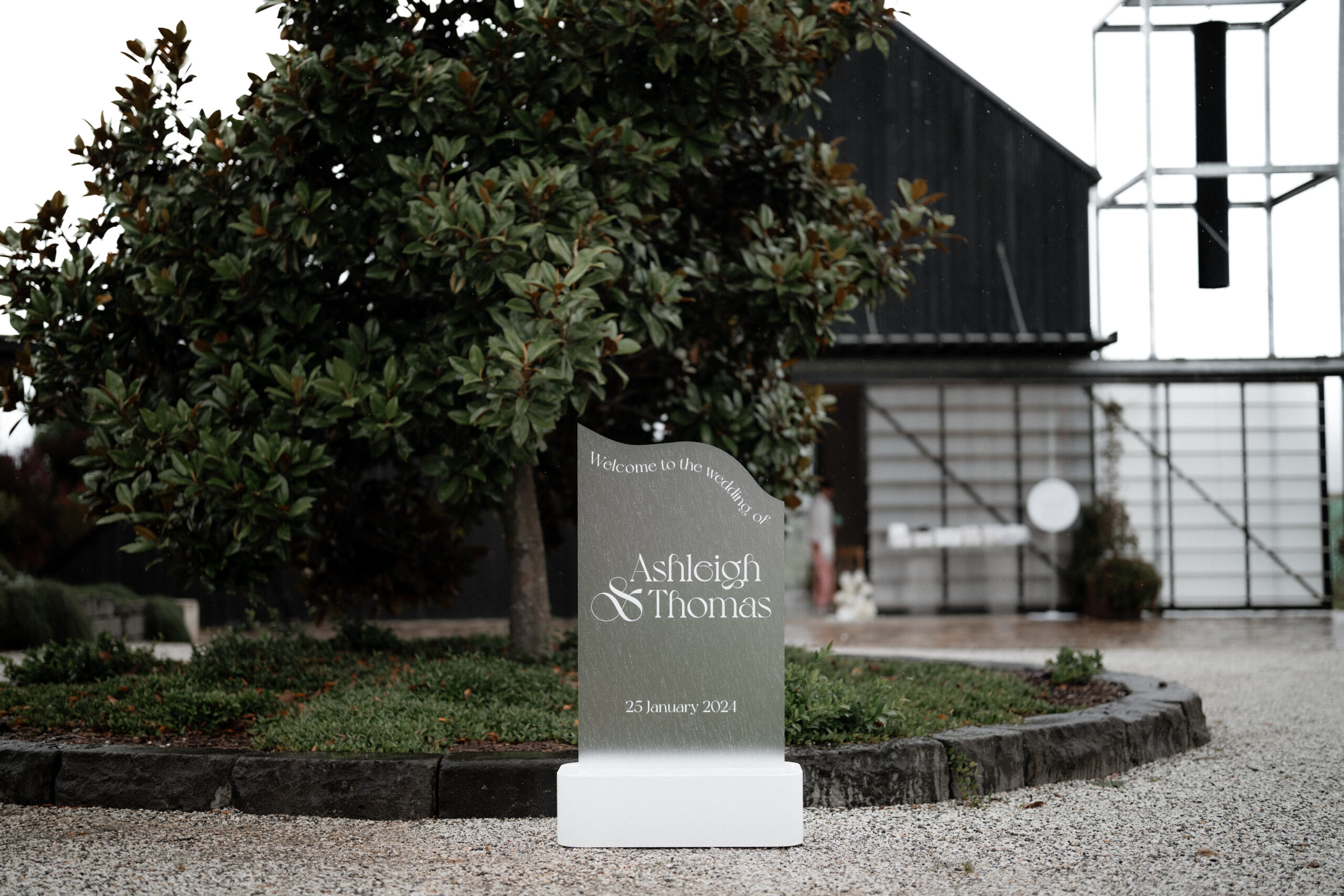 Modern wedding welcome sign at Zonzo Estate featuring Ashleigh and Thomas's names.