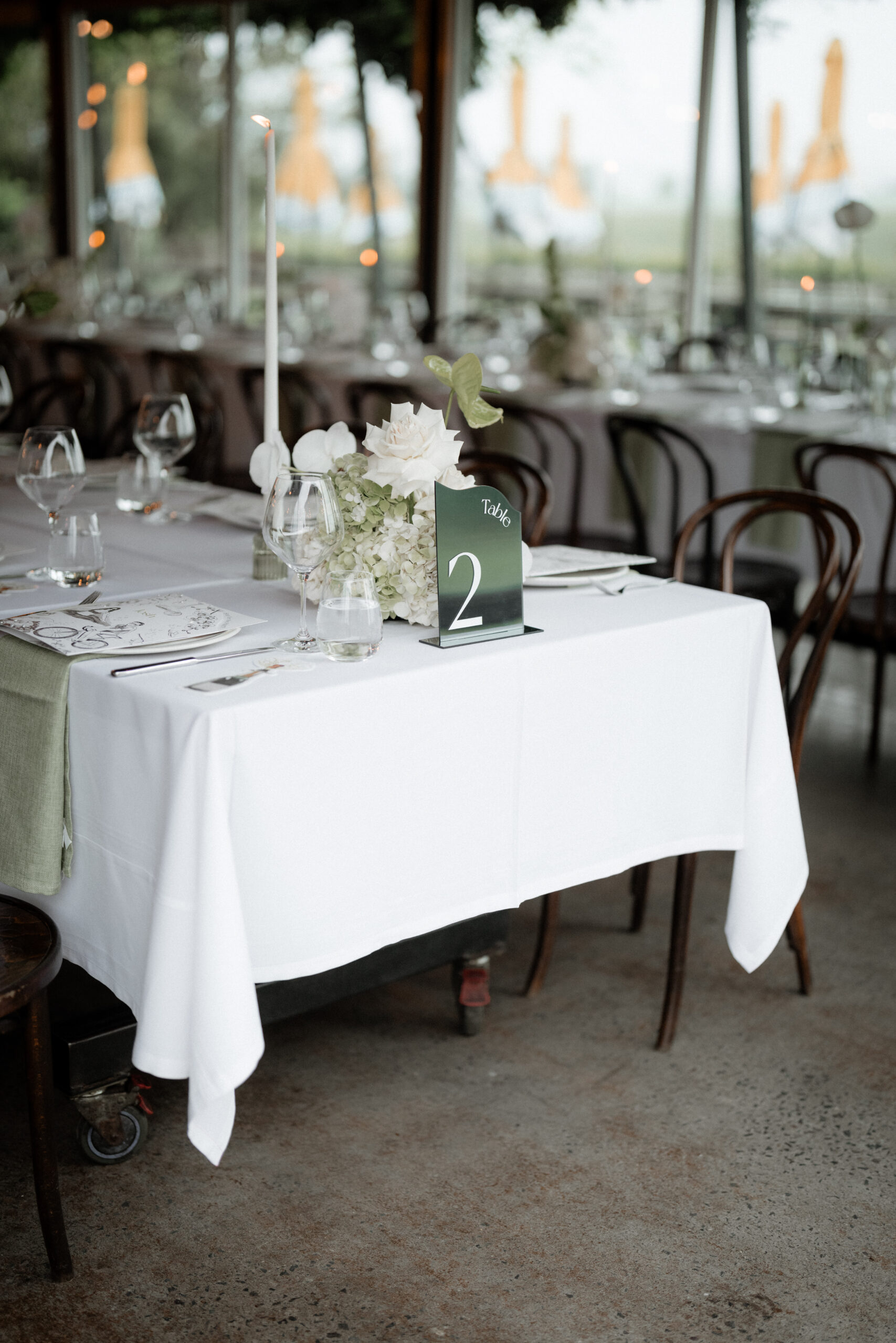 Elegant table setting with bespoke stationery and modern cutlery at a vineyard wedding.