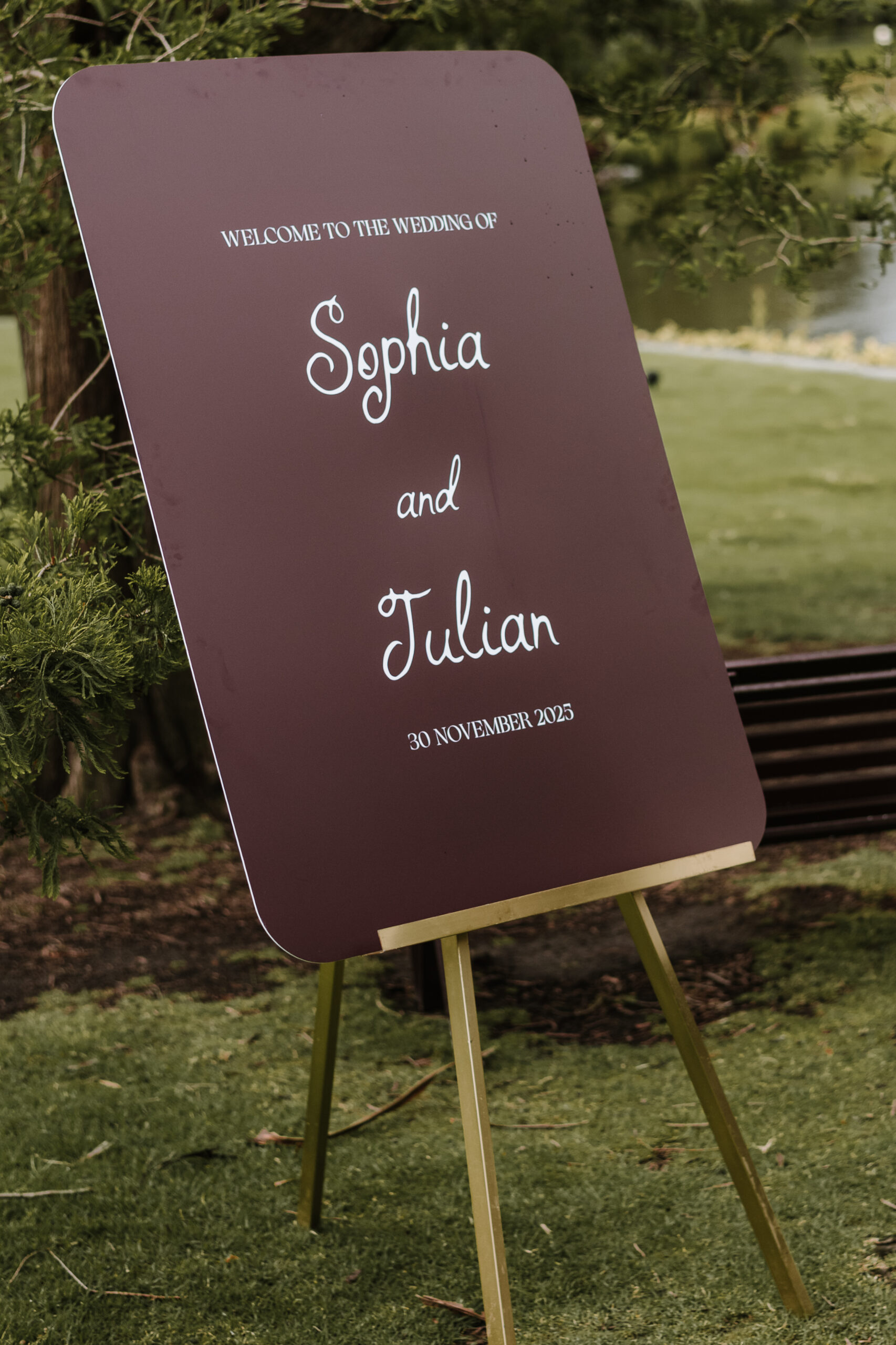 Minimalist burgundy wedding welcome sign with elegant white typography